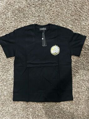 AMIRI Black Short‑Sleeve Tee with Yellow Crest Logo